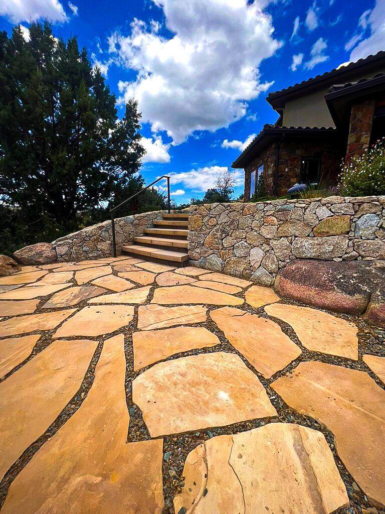 Hardscaping experts installing a custom stone patio in Cottonwood, AZ.